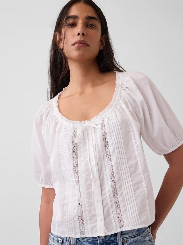 Blusa corta con pinzas y mangas hasta el codo