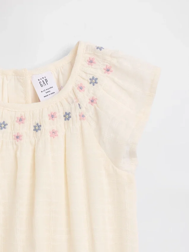 Body floral fruncido para bebé