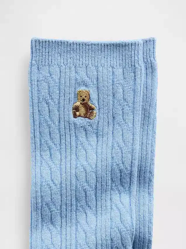 Calcetines de caña con punto trenzado y el oso Brannan