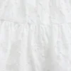 Camiseta sin mangas infantil con volantes y ojales