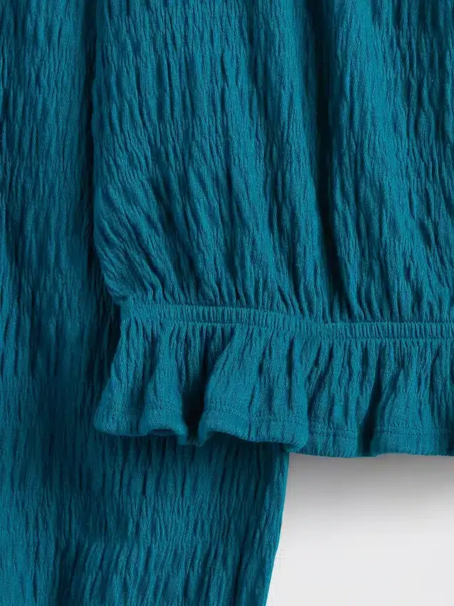Partes de arriba infantiles con peplum arrugado